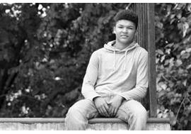 Teenage Boy Sitting Outdoors