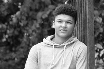 Teenage Boy Sitting Outdoors