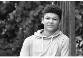 Teenage Boy Sitting Outdoors