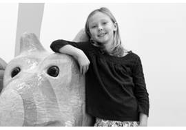 Young Girl Leaning on Animal Friend