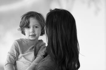 Young boy in mom's arms