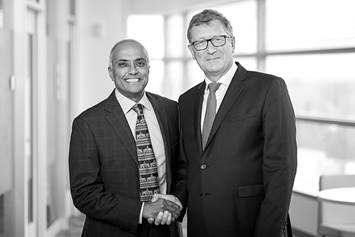 Rama Jayanthi, MD, shakes hands with Peter Cuckow, MB, BS, FRCS