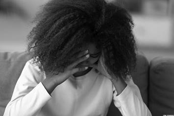 Child sitting with her head down