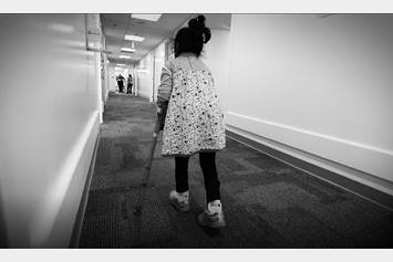 Child walking with crutches.
