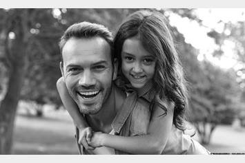 image of father and daughter playing and smiling