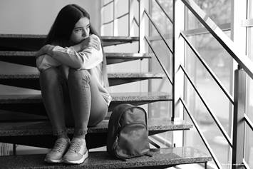 Young lady looking out a window.