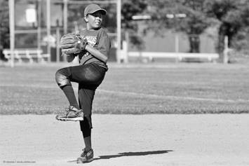 young baseball player throwing a pitch