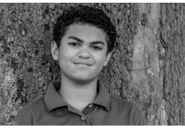 Pre Teen Boy Standing by a Tree