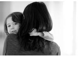 Son Looking Over Mom's Shoulder