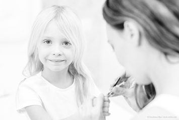 young girl getting her nails clipped